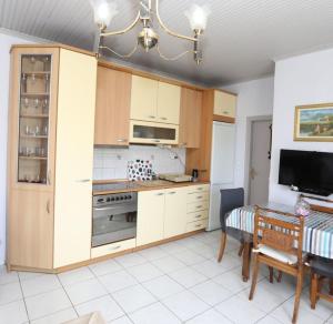 a kitchen with a table and a dining room at DIANA'S HOUSE in Khrisókastron