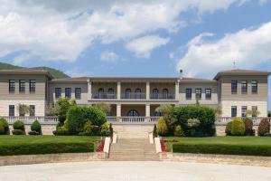 a large building with a staircase in front of it at DIANA'S HOUSE in Khrisókastron