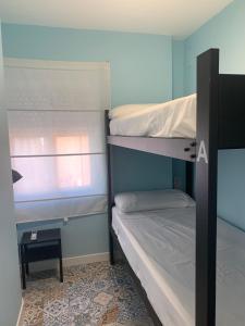 two bunk beds in a room with a window at Home SEA&DREAMS OldTown V in Calpe