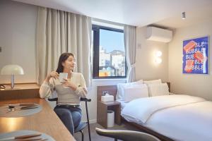 Postel nebo postele na pokoji v ubytování Aank Hotel Busan Nampo