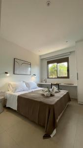a large bedroom with a large bed with a window at Lagouvardos Beach House in Marathopolis