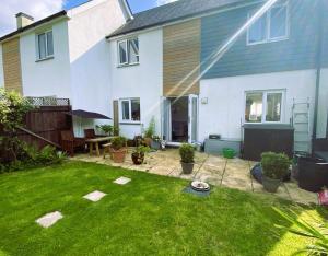 a backyard of a house with a grass yard at Bodmin Rest 4 U in Bodmin
