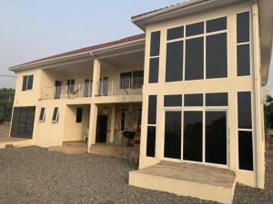 a house with large windows and a balcony at Beautiful one bed apartment in Tema Community 6 in Tema