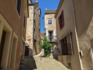 an alley in an old town with a building at La Licorne - Renovated Townhouse in St Gengoux in Saint-Gengoux-le-National