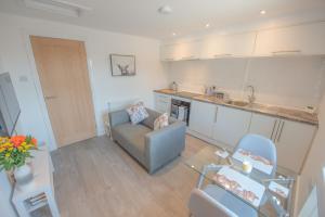 a living room with a couch and a table at Modern Apartment in Town Centre Skipton in Skipton