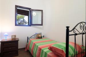 A bed or beds in a room at Trullo - Cantoru by LoveSud