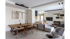 a living room with a table and a couch at Salina SPA Villas - with PRIVATE HEATED ECO-POOL, SAUNA & JACCUZI HOT TUB in Volos