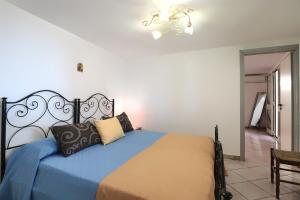 A bed or beds in a room at Trullo - Cantoru by LoveSud