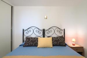 A bed or beds in a room at Trullo - Cantoru by LoveSud