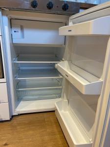 an empty refrigerator with its door open in a kitchen at Loft Studio, Excellent Central City Location in Cambridge