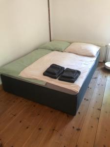 un letto con due asciugamani neri sopra di Gemütliche Ferienwohnung an der Elbe a Bleckede