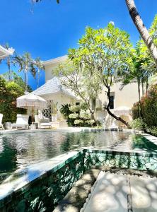 a swimming pool in the backyard of a house at Moon Villas Umalas in Canggu