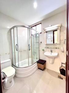 a bathroom with a shower and a toilet and a sink at Nanwa House in Ho Chi Minh City