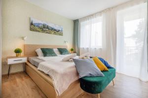 a bedroom with a large bed and a window at FEEL HOME Superior-FREE PARKING-BALCONY-AC-Elevator in Budapest