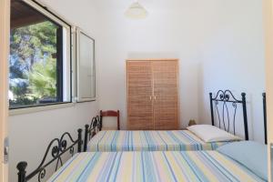 A bed or beds in a room at Trullo - Cantoru by LoveSud
