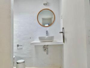 a white bathroom with a sink and a mirror at Villa Ocean View in Pedro Barba