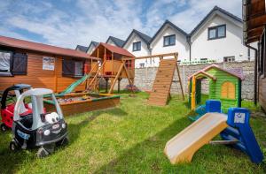 a yard with playground equipment and a house at Uroczy Zakatek in Chłopy