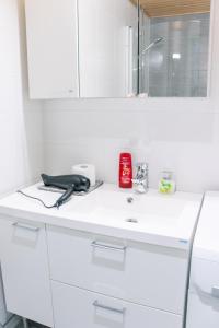 a white counter top with a hair dryer and a mirror at Top location IICenter IIParking in Oulu