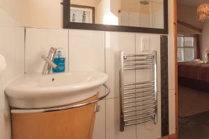 a bathroom with a sink and a mirror at Zion Place in Dartmouth +14 photos