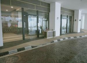 a lobby of a building with a person sitting in a counter at Cozy 3 Guests High Floor at Puteri Harbour L22 in Nusajaya