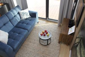 a living room with a blue couch and a table at Galena i Gnejs in Stronie Śląskie +122 photos