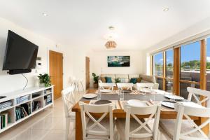 a dining room and living room with a table and chairs at Apartment 144 - Clifden in Clifden