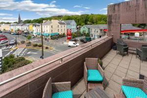 a balcony with chairs and a view of a street at Apartment 144 - Clifden in Clifden