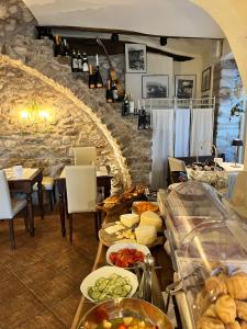 a restaurant with a table filled with different types of food at charmante apartament lake front in Malcesine