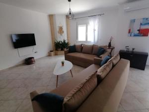 a living room with a couch and a table at Native Living in Polykhrono