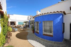 a blue and white building with a patio at B&B Sant Pol - Adults Only in San Pol de Mar