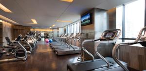a gym with a row of treadmills at JW Marriott Hotel Chongqing in Chongqing