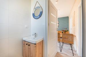 a bathroom with a sink and a mirror on the wall at MIELENKO BEACH - domki in Mielenko +40 photos