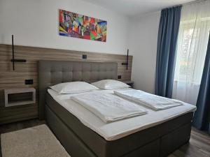 a bedroom with a large bed with white sheets at Premium Apartments Tade Funtana in Funtana