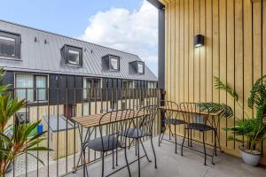 a patio with two tables and chairs on a balcony at Chi An Treth in Hayle