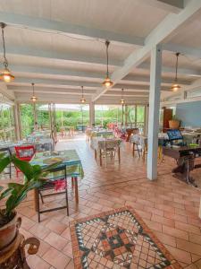 a large room with tables and chairs and a piano at Ennesima Osteria con Alloggio - Bike Hotel in Toscolano Maderno