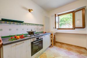a kitchen with a stove and a sink and a window at Casa Mondragon In Lazise - Happy Rentals in Lazise