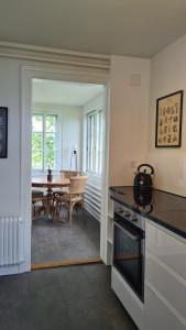 a kitchen with a table and a dining room at Swiss Holiday Apartments in Spiez
