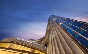 a building with a sign on the side of it at JW Marriott Hotel Chongqing in Chongqing
