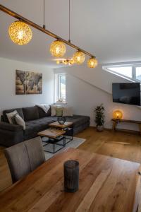 a living room with a couch and a table at mivida - Apartment Geierkogel in Hohentauern