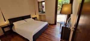 a bedroom with a bed and a lamp and a door at Villa con fascino antico e comfort moderno in Trecastagni +46 photos