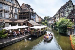 a group of people in a boat on a river at CityKamp Colmar in Horbourg