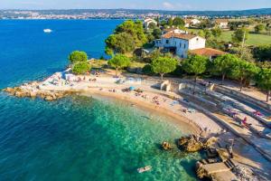 an aerial view of a beach with people in the water at Tea Deluxe Apartment with private Pool in Malinska