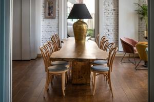 a dining room table with chairs and a lamp on top at Sava Boutique Hotel in Warsaw