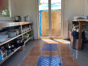 a kitchen with an open door to a patio at mongolische Jurte im ART.Quartier in Velgast