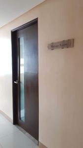 a door in a building with a sign that reads manage room at 101 Newport blvd C2 4F by Rechelle Nunag in Manila