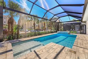 a swimming pool with a glass roof over it at 280 West Flamingo Circle in Marco Island