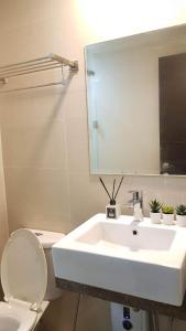 a bathroom with a sink and a toilet and a mirror at 101 Newport blvd C2 4F by Rechelle Nunag in Manila