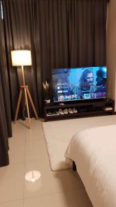 un soggiorno con una grande TV a schermo piatto di 101 Newport blvd C2 4F by Rechelle Nunag a Manila