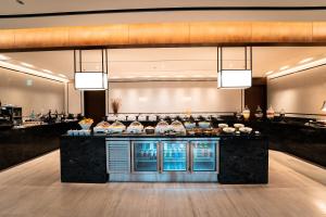 a restaurant with a counter with food on it at LOTTE Hotel Serviced Apartment in Yangon