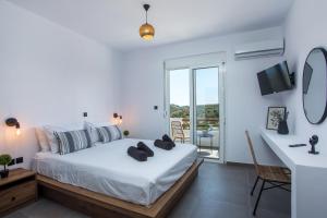 a white bedroom with a bed and a balcony at Villa Tranquila Rhodes in Psinthos +87 photos